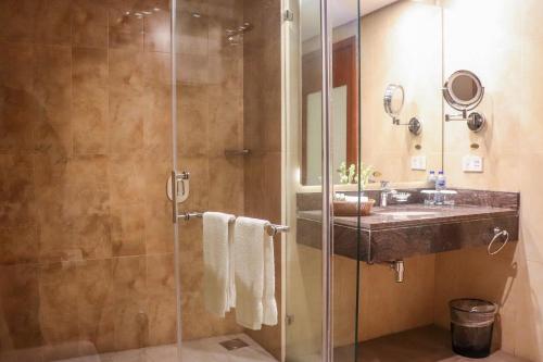 a bathroom with a sink and a shower at Avari Boutique Multan in Multan