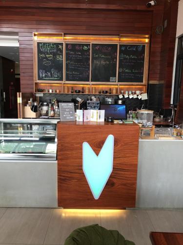 a restaurant counter with a blue sign on it at Ptas Tauch Residence in Phnom Penh