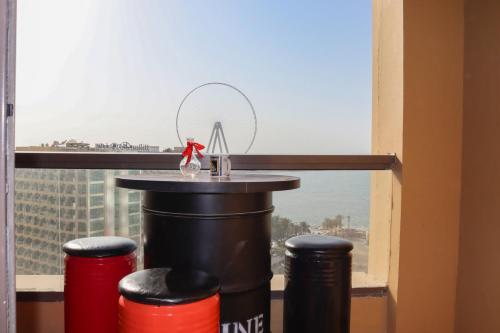 
a bottle of water sitting on top of a table next to a window at California Hostel Dubai Beach in Dubai
