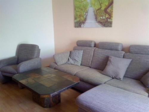 a living room with a couch and a coffee table at Gästewohnungen Hennig in Markkleeberg