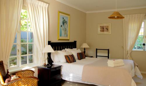 a bedroom with a large white bed and windows at Bicycle Lodge Apartment in Tokai