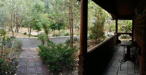 a porch of a house with a view of a garden at Zolotoy Bereg Hotel in Chernihiv