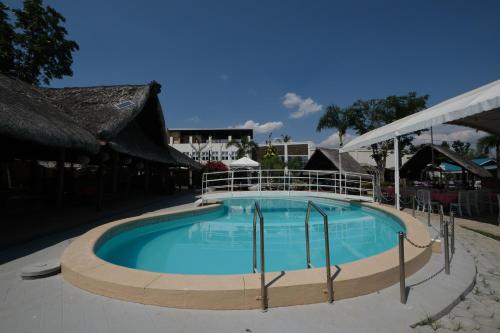a large swimming pool in the middle of a resort at Balai Carmela in Tuguegarao City