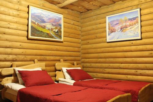 a hotel room with a bed, chair, and table at "LiAn" Family Hotel & Restaurant in Volosyanka
