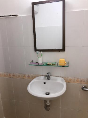 a bathroom with a white sink and a mirror at VIỆT Hostel in Hue