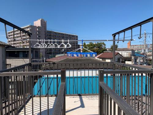 a view of a swimming pool from a balcony at Vivian house in Tokyo