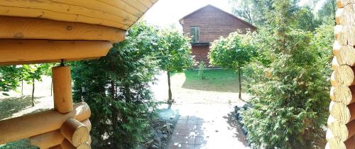 an outside view of a house with trees and a building at Zolotoy Bereg Hotel in Chernihiv