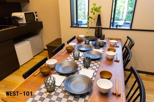 une table en bois avec des assiettes et des bols dans l'établissement Stagione Hakone Yumoto, à Hakone