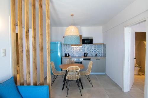 a kitchen with a table and chairs in a room at Varkotopi Villas in Agios Pavlos