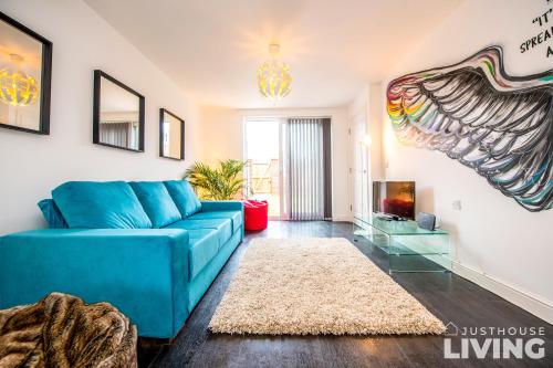 a living room with a blue couch and a rug at NEW Spacious Modern Townhouse Sleeps 12 Free Parking in Liverpool