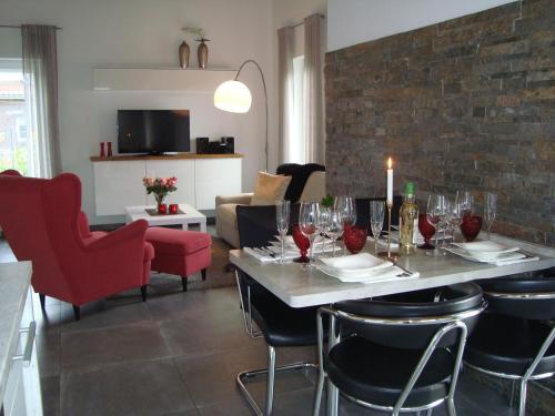 a dining room with a table with wine glasses at Strandlust II in Petersfeld