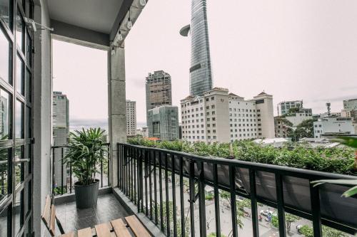 a balcony with a view of the city at CIRCADIAN Industrial Studios on Nguyen Hue in Ho Chi Minh City