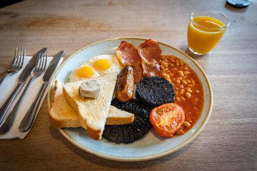 a plate of breakfast food with eggs beans and toast at The Potting Shed Maidstone in Langley