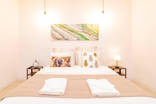 a bedroom with a large bed with two white towels at Marvelous Duplex 3 Bedrooms in La Latina by Batuecas in Madrid