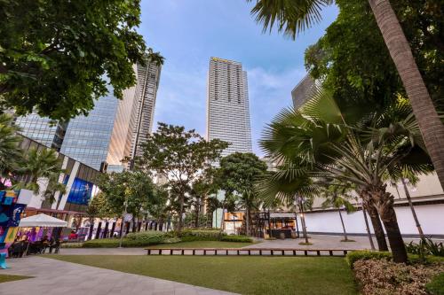 a park in a city with tall buildings at Shangri-La Residences The Fort, Manila in Manila