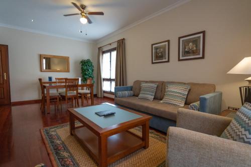 a living room with a couch and a table at Laguna Nivaria Hotel & Spa in La Laguna