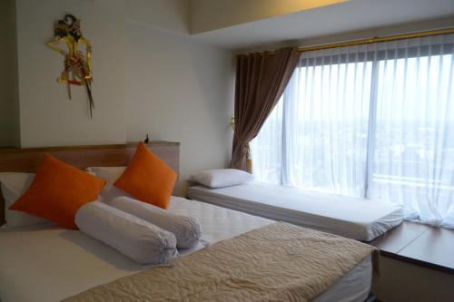 Ένα ή περισσότερα κρεβάτια σε δωμάτιο στο The Cabin Apartment Uttara