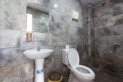 a bathroom with a toilet and a sink at Green garden house in Hoi An