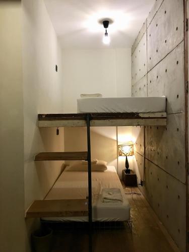 a room with two bunk beds and a lamp at Eia by Dawata in Cebu City