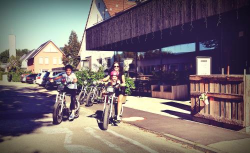 a group of people riding bikes down a street at Melbo's Home in Lindau