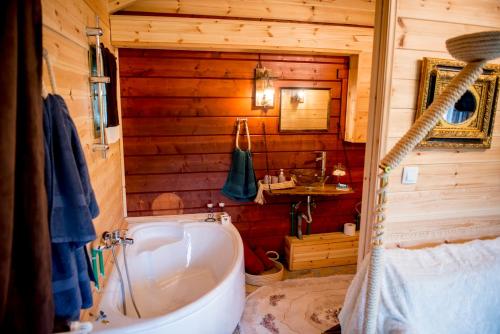 a bathroom with a tub and a sink in a cabin at Kedra Village in Kédra