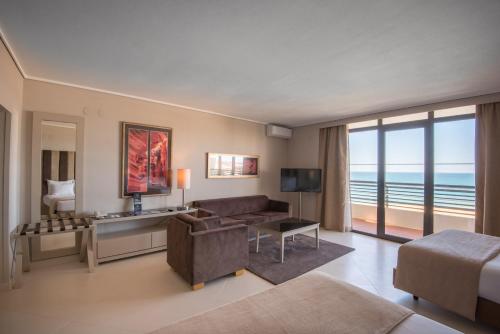 a living room with a couch and a room with a view at Vila Gale Ampalius in Vilamoura
