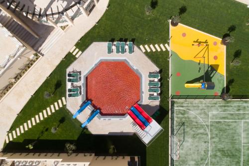 an overhead view of a building with a swimming pool at Vila Gale Ampalius in Vilamoura