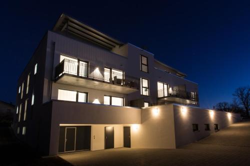 a building at night with its lights on at Boardinghouse E68 in Schliengen