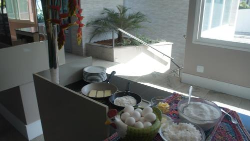 a kitchen with some food on a table at Hotel Barramares in Recife