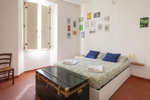 a bedroom with a bed with blue pillows and a table at Appartamento 122 in Prato