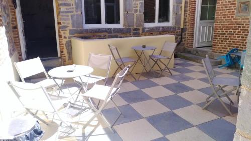 a group of chairs and tables on a patio at Comme chez soi in Givet