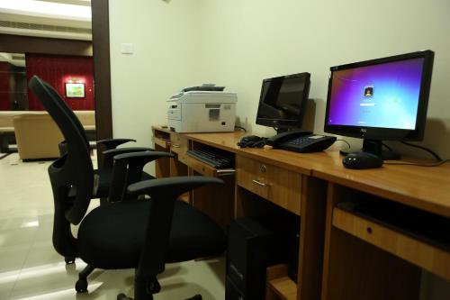 an office with a desk with a computer and a monitor at Hotel Airlink Castle in Nedumbassery