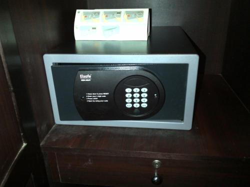 a microwave oven with a box on top of it at Hotel Airlink Castle in Nedumbassery