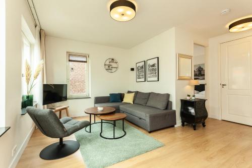 a living room with a couch and a table at Stayci Serviced Apartments Central Station in The Hague
