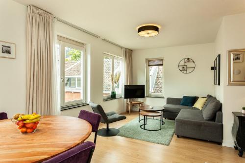 a living room with a table and a couch at Stayci Serviced Apartments Central Station in The Hague