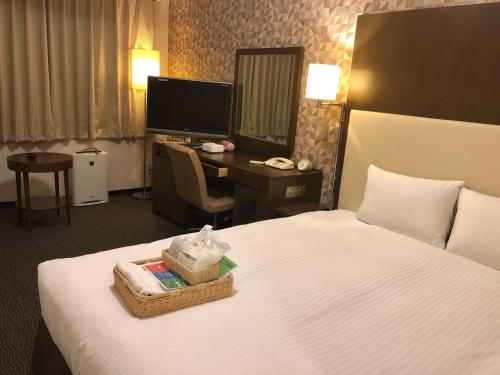 a hotel room with a bed and a desk at Hotel IL Cuore Namba in Osaka