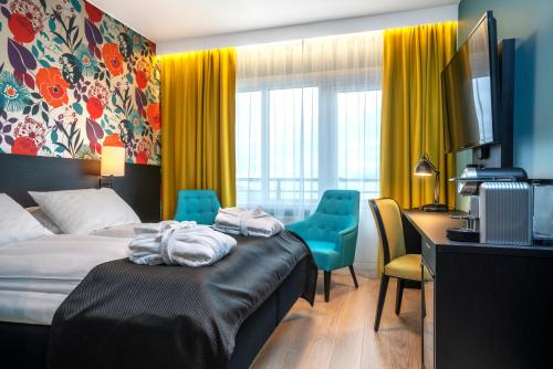 a hotel room with a bed and a desk at Thon Hotel Harstad in Harstad
