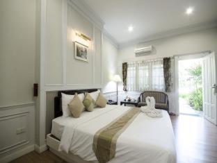 a bedroom with a large white bed in a room at Rachawadee Resort & Hotel in Khon Kaen