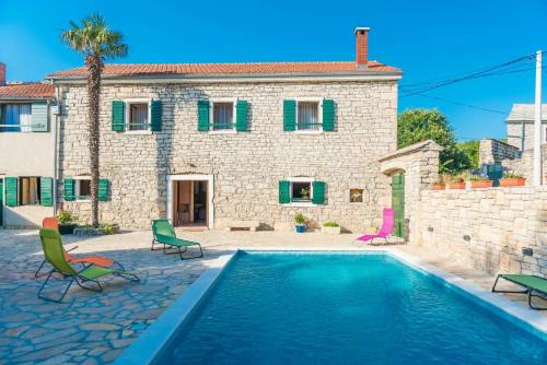 a house with a swimming pool in front of a house at Villa Petrovi Dvori ZadarVillas in Benkovac