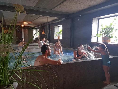 a group of people in a hot tub at Hotell & Spa Lögnäs Gård in Laholm