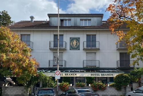 a building with a clock on the front of it at Hotel Bramen in Kloten