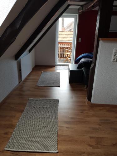 a living room with two rugs on a wooden floor at Gästeoase einfach wohl fühlen in Wolfhagen