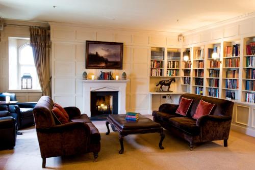 a living room with two couches and a fireplace at Lough Eske Castle in Donegal