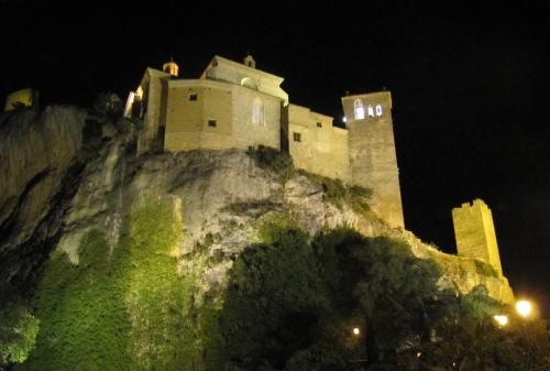 a castle on top of a mountain at night at Apartamentos San Gregorio in Alquézar