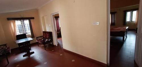 a living room with a table and a dining room at Bruton resorts in Kodaikānāl
