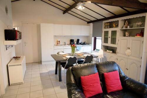 a living room with a table and a couch at Zeepark Zeewind in Bredene