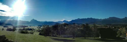 a view of a valley with mountains in the background at Ferienwohnung Alpenpanorama in Hopferau