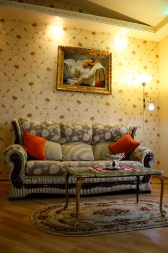 a living room with a couch and a painting on the wall at Rayske Yabloko in Lviv