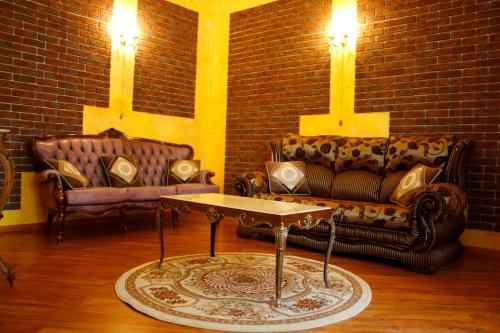 a living room with couches and a brick wall at Rayske Yabloko in Lviv