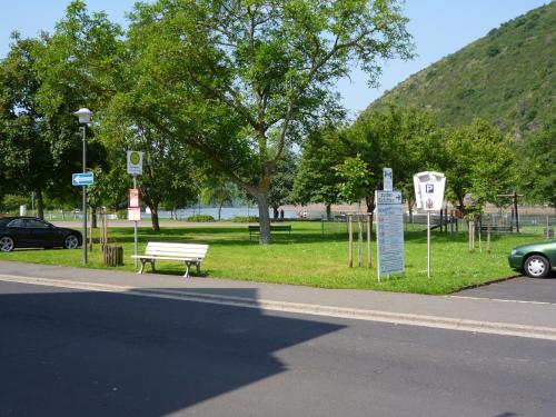 a park with a bench on the side of a road at Hotel Garni Reis in Treis-Karden